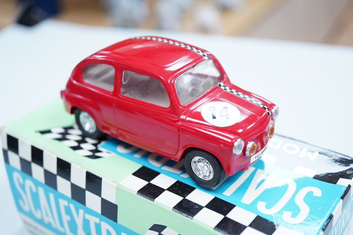 A boxed Tri-ang Scalextric T. C. Seat 600 (C-31) in red, with correct red spot box, together with an unboxed Hurricane combination motorcycle and sidecar MM/82